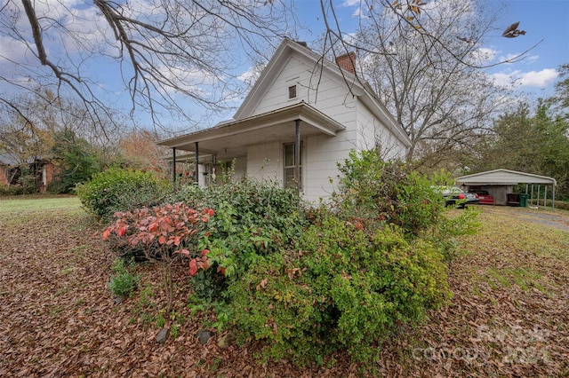 view of side of home with a carport