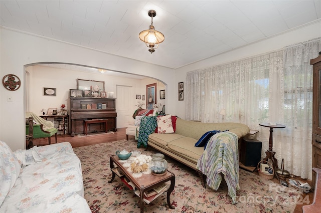 living room featuring hardwood / wood-style flooring and ornamental molding