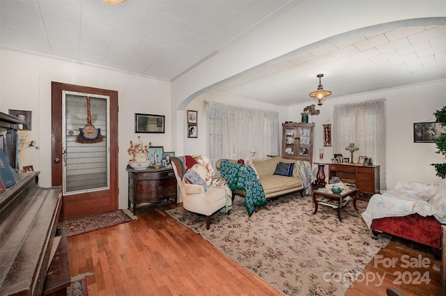 living room with crown molding and dark hardwood / wood-style floors