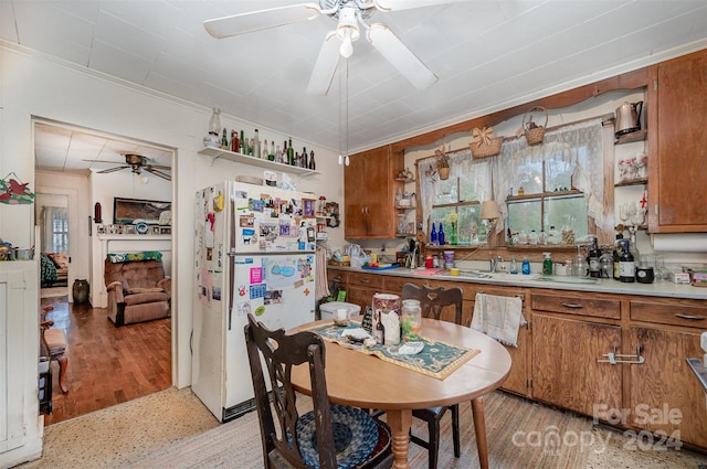 kitchen featuring ceiling fan, white fridge, light hardwood / wood-style floors, and ornamental molding