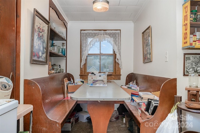 carpeted dining room featuring crown molding