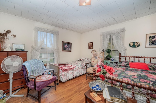 bedroom featuring crown molding and hardwood / wood-style floors