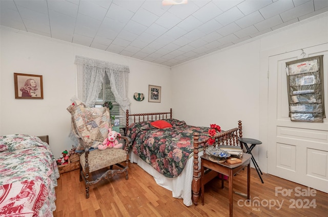 bedroom featuring crown molding and hardwood / wood-style floors