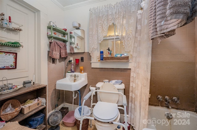 full bathroom featuring shower / bath combo, sink, toilet, ornamental molding, and tile walls