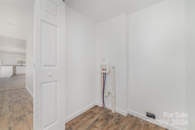 clothes washing area with hookup for a washing machine and wood-type flooring