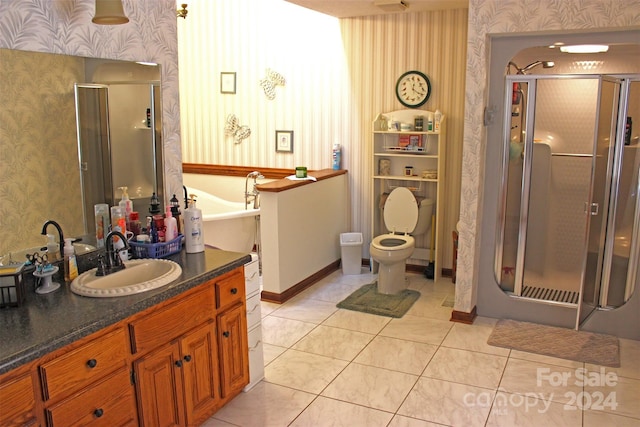 bathroom with tile patterned flooring, vanity, toilet, and a shower with door