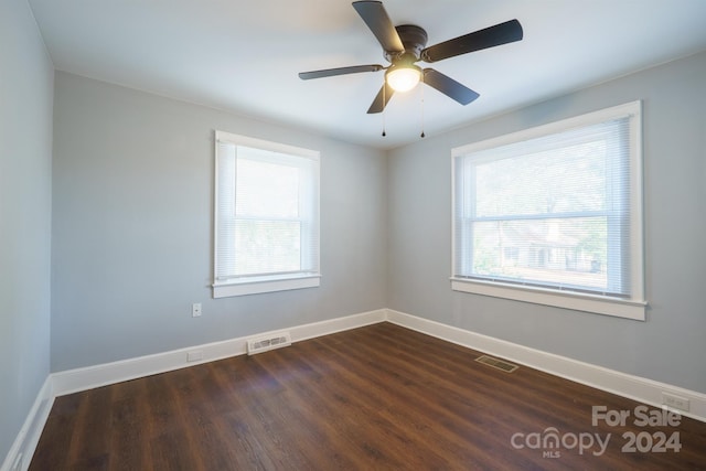 empty room featuring ceiling fan and dark hardwood / wood-style flooring