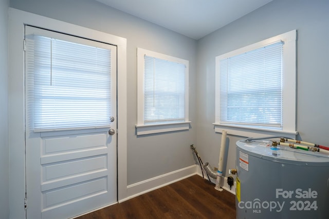 doorway featuring water heater and dark hardwood / wood-style floors