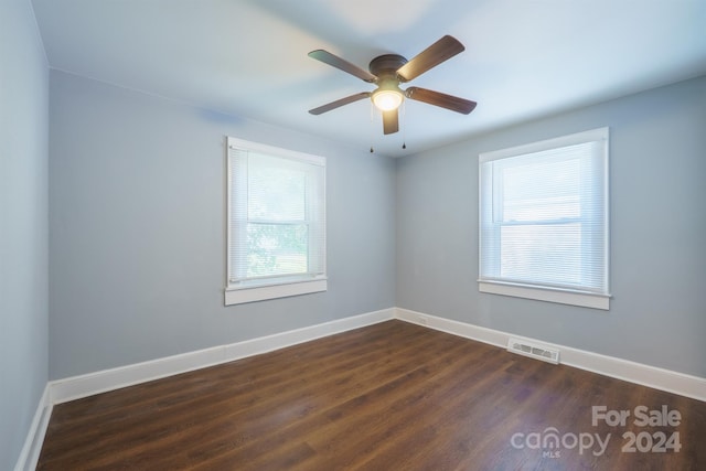 unfurnished room featuring ceiling fan and dark wood-type flooring