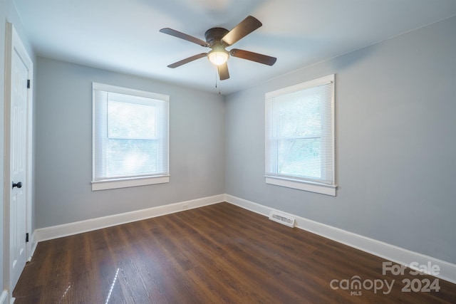 unfurnished room with ceiling fan and dark hardwood / wood-style floors