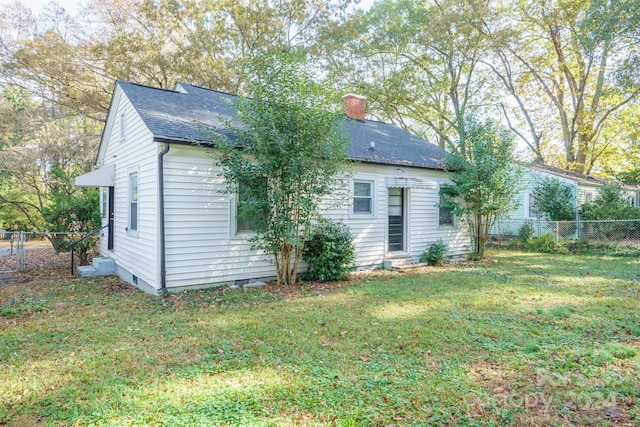 rear view of property with a lawn