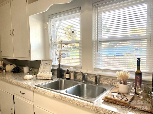 kitchen featuring sink and white cabinets