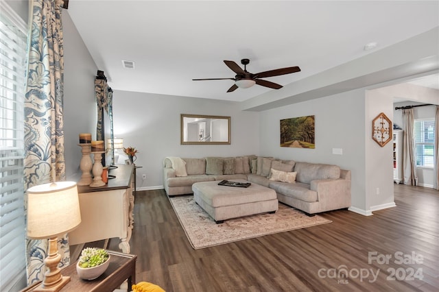 living room with ceiling fan and dark hardwood / wood-style flooring