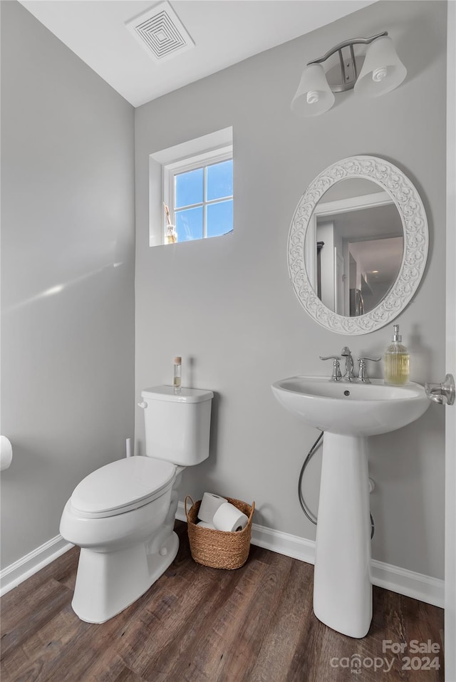 bathroom featuring hardwood / wood-style floors and toilet