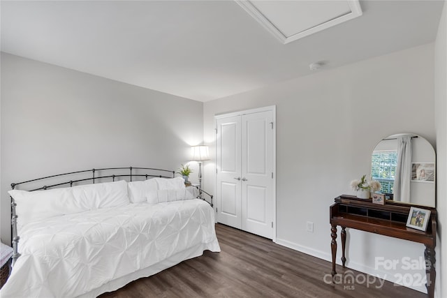 bedroom featuring a closet and dark wood-type flooring