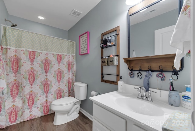 bathroom featuring vanity, curtained shower, toilet, and wood-type flooring