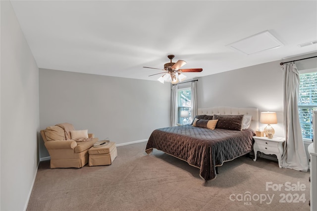 bedroom with multiple windows, ceiling fan, and carpet floors