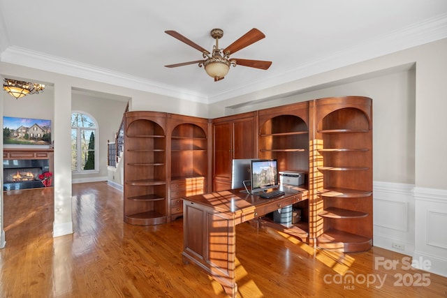 office area featuring hardwood / wood-style floors, ceiling fan, and ornamental molding