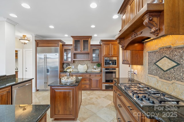 kitchen with tasteful backsplash, dark stone countertops, ornamental molding, and appliances with stainless steel finishes