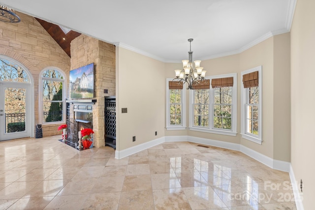 unfurnished room with crown molding, a fireplace, lofted ceiling, and an inviting chandelier