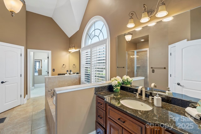 bathroom with tile patterned floors, vanity, an enclosed shower, and high vaulted ceiling