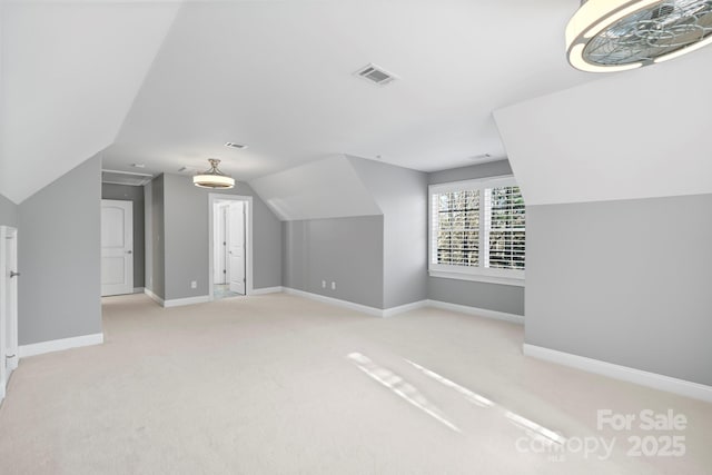 bonus room featuring light colored carpet and vaulted ceiling