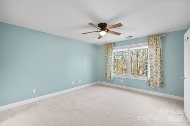 carpeted empty room featuring ceiling fan