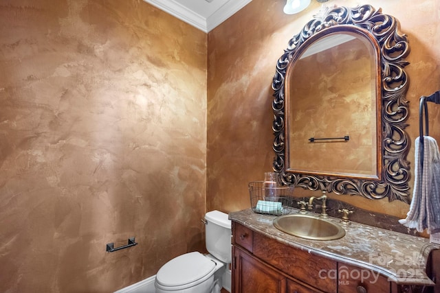 bathroom with vanity, toilet, and ornamental molding