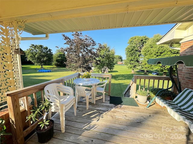 wooden deck featuring a yard