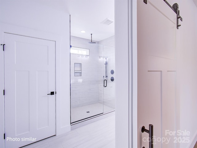 bathroom with a shower with shower door