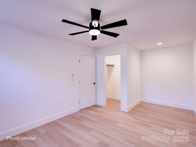 unfurnished room with ceiling fan and light hardwood / wood-style flooring