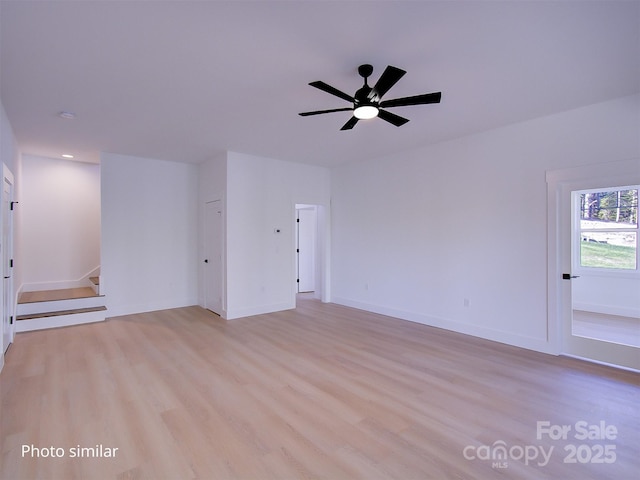 unfurnished room featuring ceiling fan and light wood-type flooring