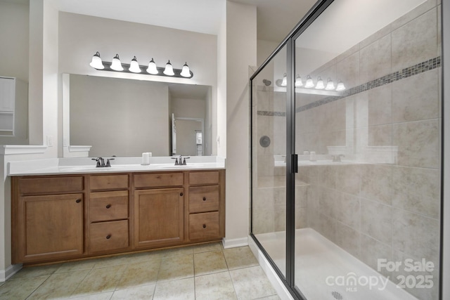 bathroom with tile patterned flooring, vanity, and an enclosed shower