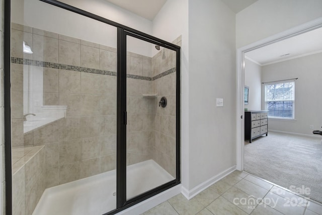 bathroom featuring tile patterned flooring, ornamental molding, and a shower with shower door