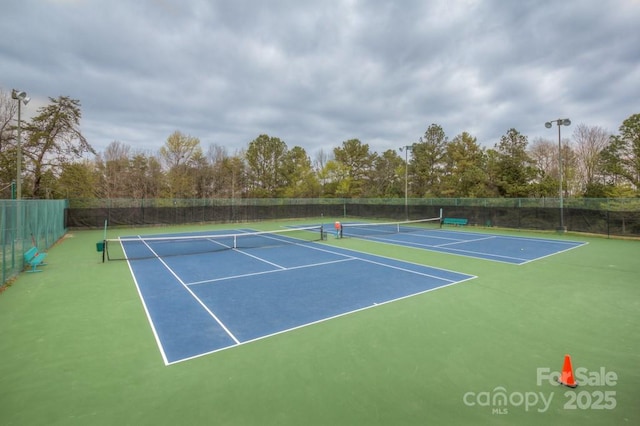 view of tennis court featuring basketball court