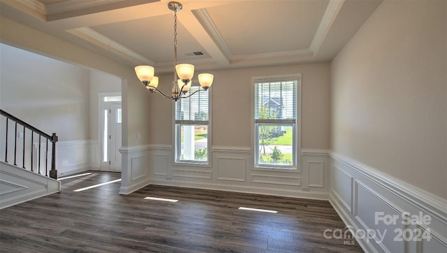 unfurnished dining area featuring a tray ceiling, crown molding, dark wood-type flooring, and a notable chandelier