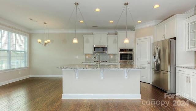 kitchen featuring white cabinets, a kitchen breakfast bar, stainless steel appliances, and dark hardwood / wood-style floors