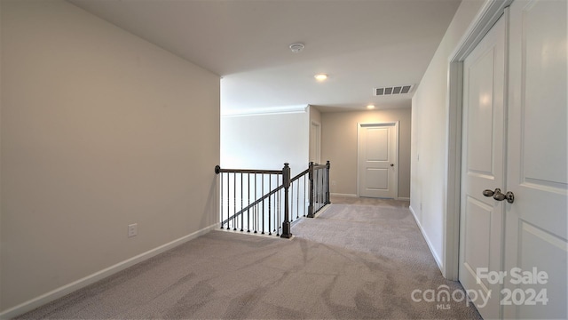 hallway featuring light carpet