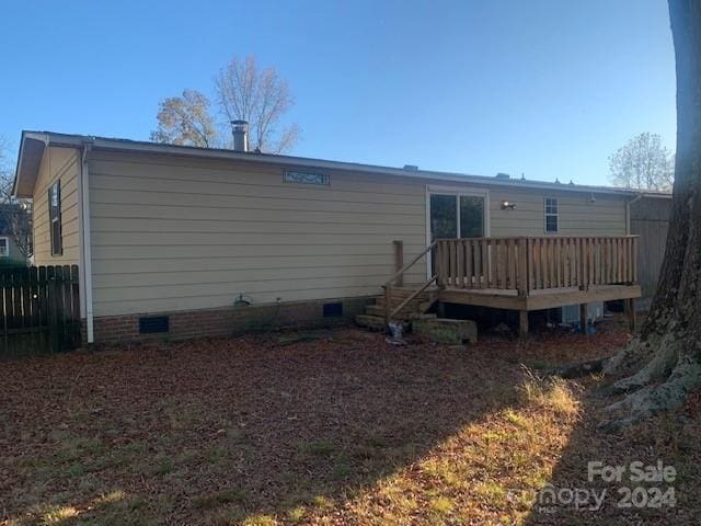 back of property featuring a deck