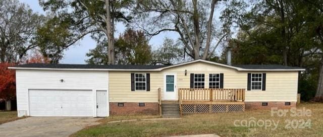 view of front of property with a garage and a deck