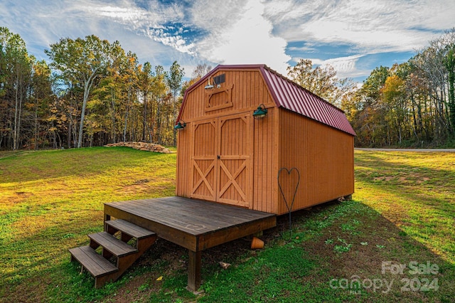 view of outbuilding featuring a yard