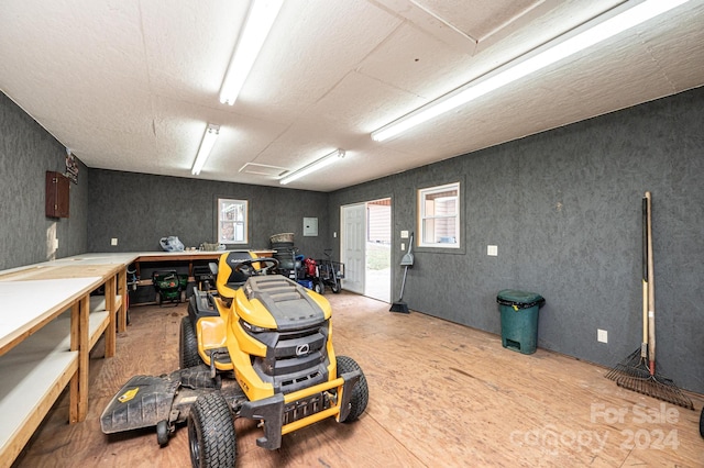 miscellaneous room with a workshop area and light wood-type flooring