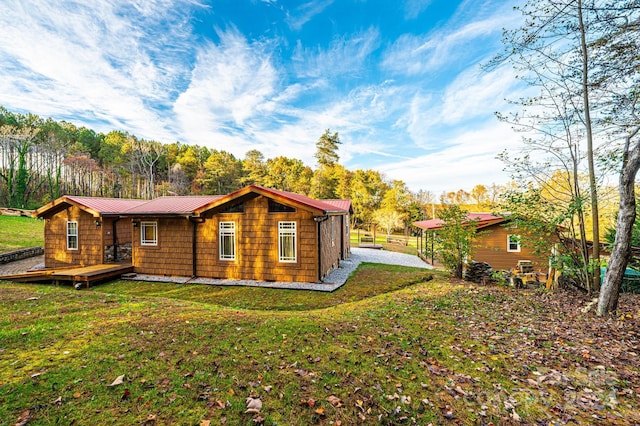 back of house featuring a deck and a yard