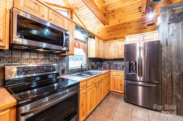 kitchen with lofted ceiling, sink, light tile patterned floors, wood ceiling, and stainless steel appliances