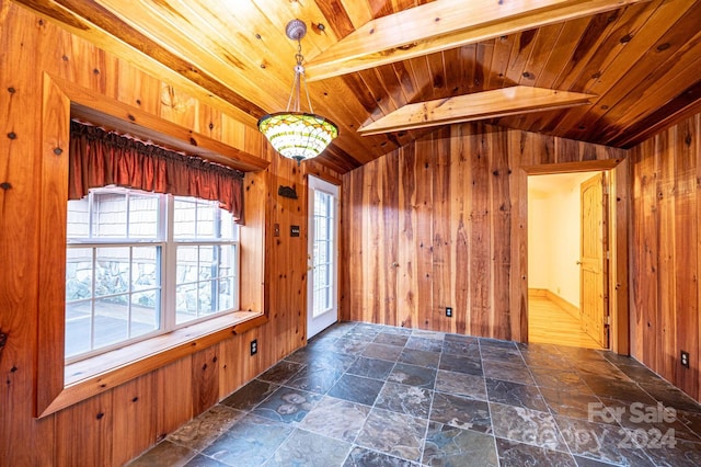 foyer entrance with wood walls and wooden ceiling