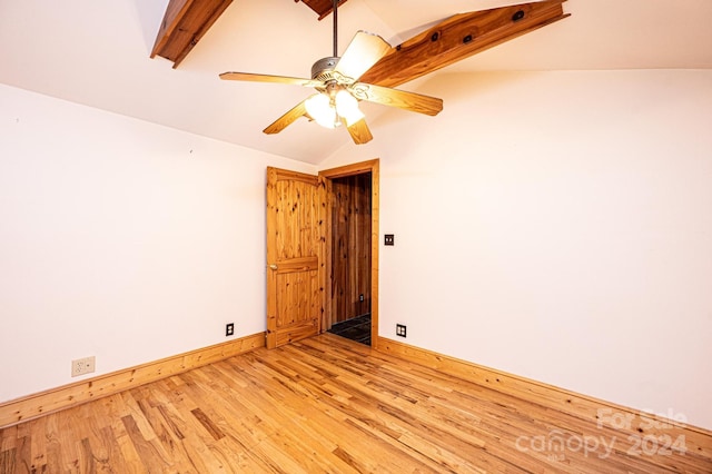 unfurnished room featuring light wood-type flooring, lofted ceiling with beams, and ceiling fan