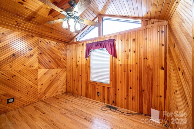 bonus room featuring hardwood / wood-style floors, a wealth of natural light, and wooden walls