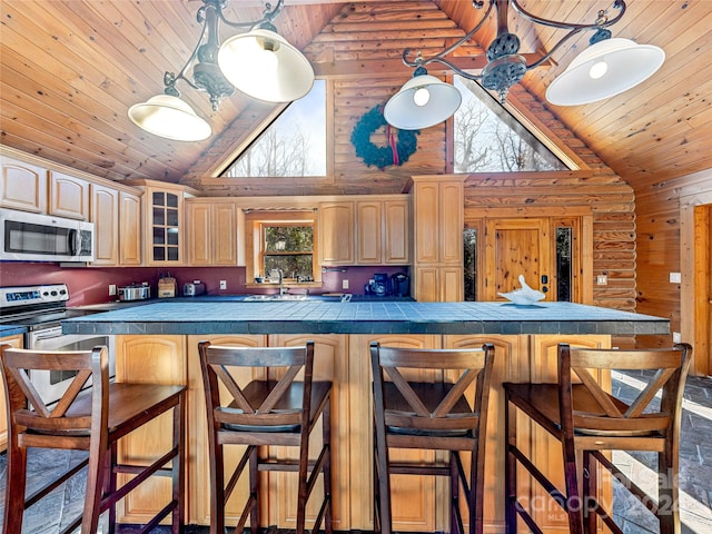 kitchen with tile countertops, wood ceiling, and stainless steel appliances