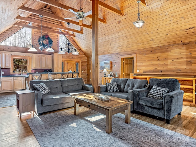 living room with hardwood / wood-style floors, beamed ceiling, and high vaulted ceiling