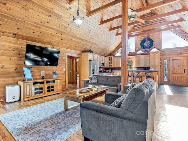 living room featuring beam ceiling, light hardwood / wood-style floors, and high vaulted ceiling